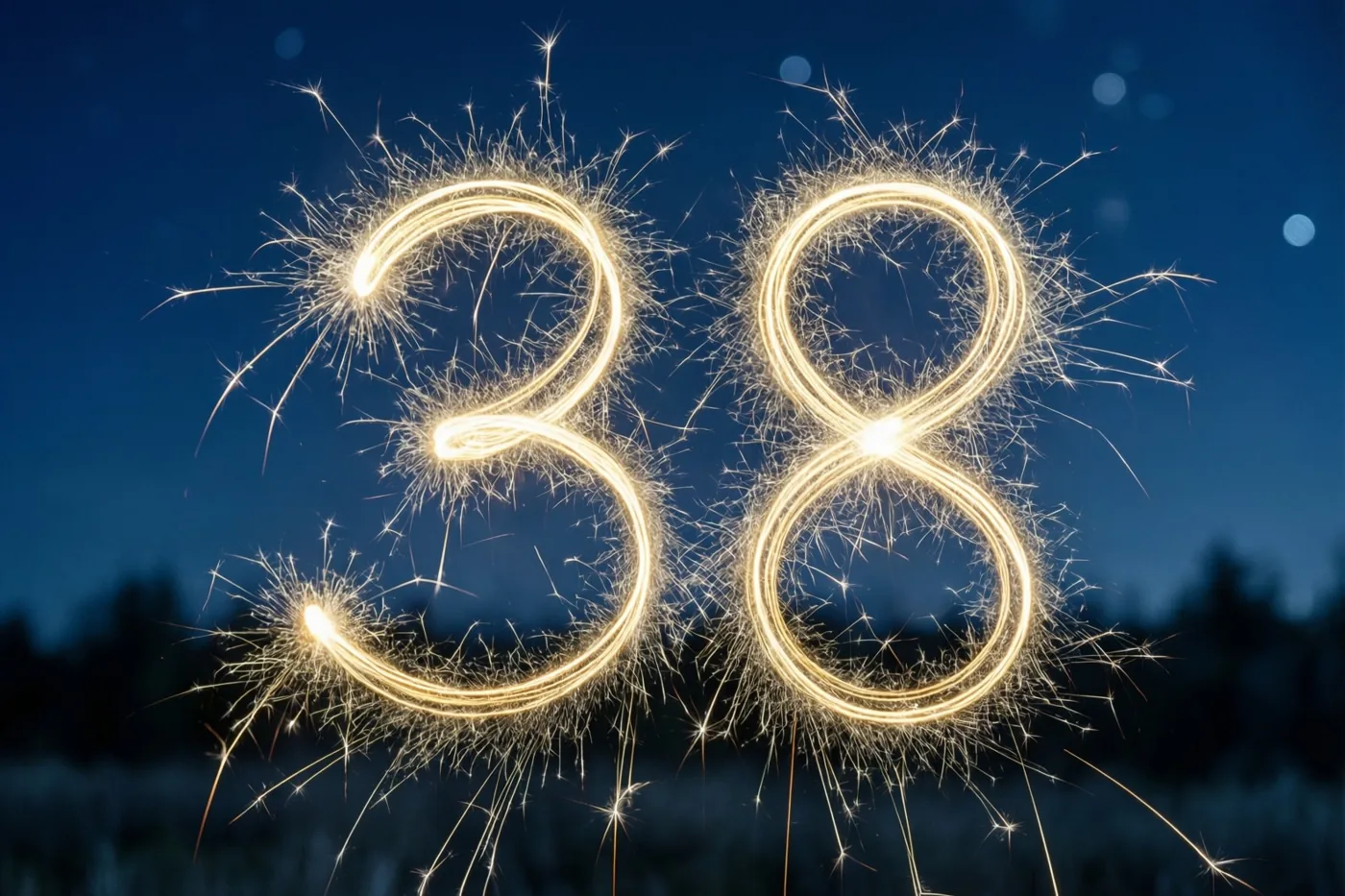 Gouden lichtsporen van sterretjes vormen het getal 38 tegen een donkerblauwe nachtelijke hemel.