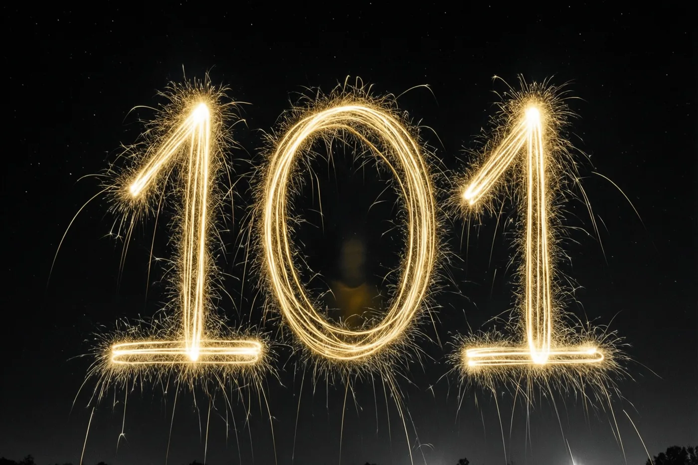 Gouden lichtsporen van sterretjes vormen 101 tegen een zwarte nachtelijke achtergrond.