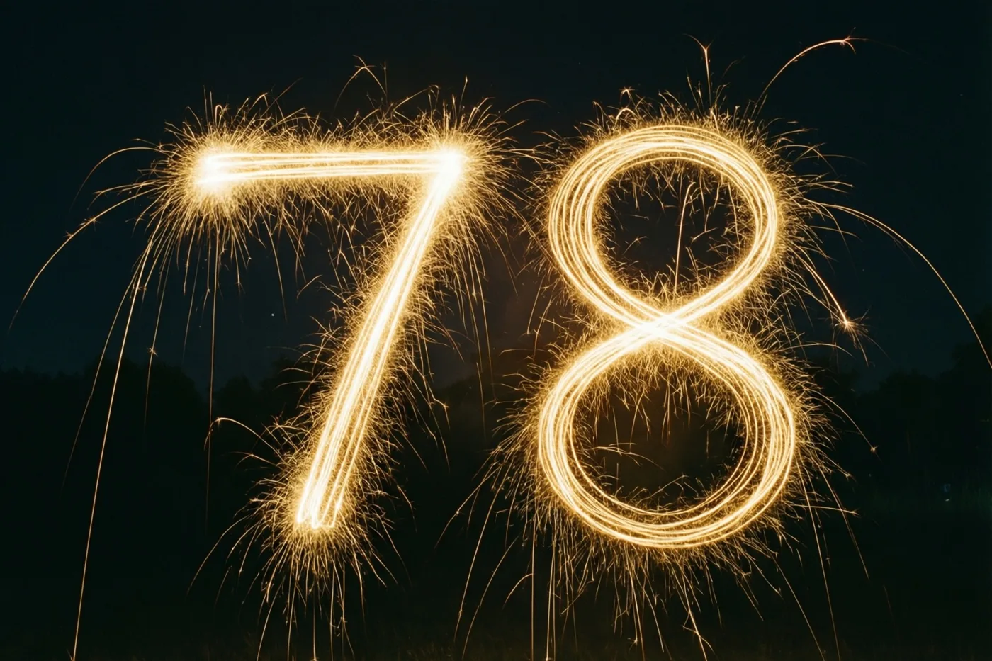 Gouden lichtsporen van sterretjes vormen 78 tegen een donkere nachthemel.
