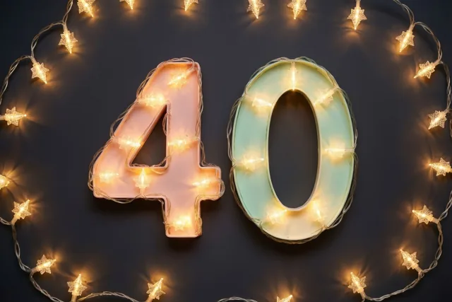Gloeiende lichtjes vormen het getal 40 op een donkere muur, met wazige gouden lichtpunten eromheen.