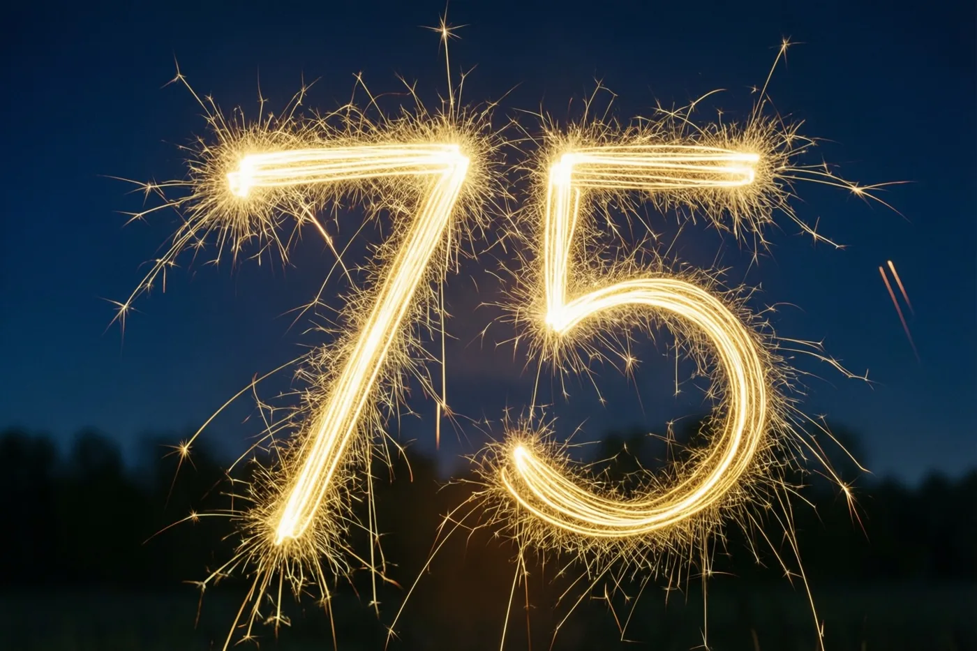 Gouden lichtsporen van sterretjes vormen 75 tegen een donkere nachthemel.