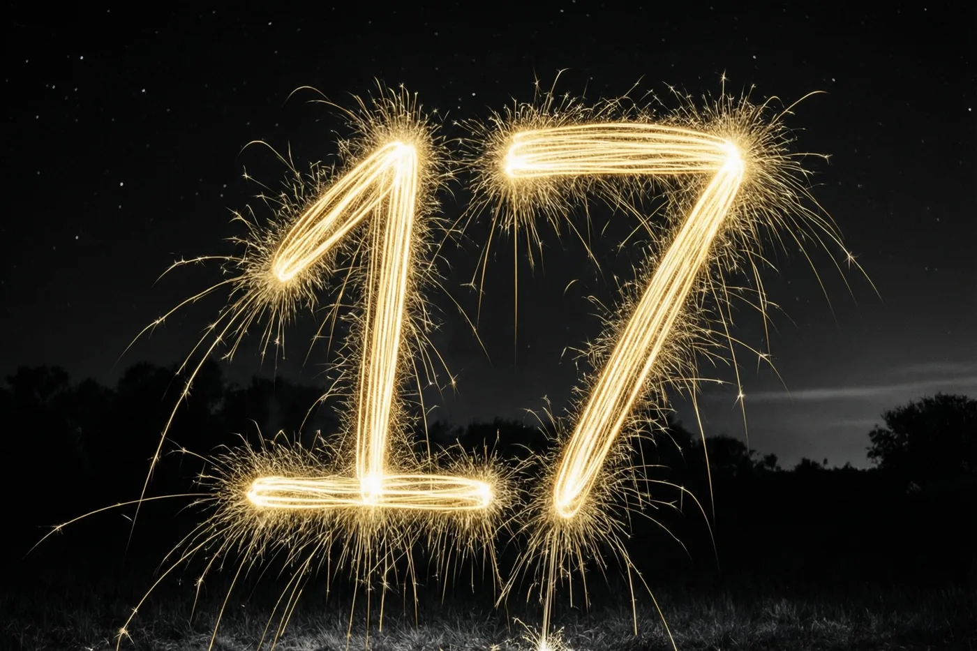 Gouden lichtsporen van sterretjes vormen het getal 17 tegen een donkere hemel met zichtbare sterren.