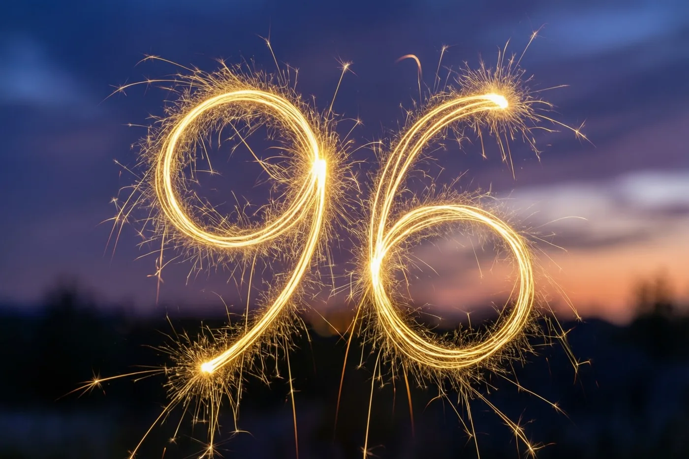 Gouden lichtsporen van sterretjes vormen 96 tegen een paars-oranje schemerlucht.