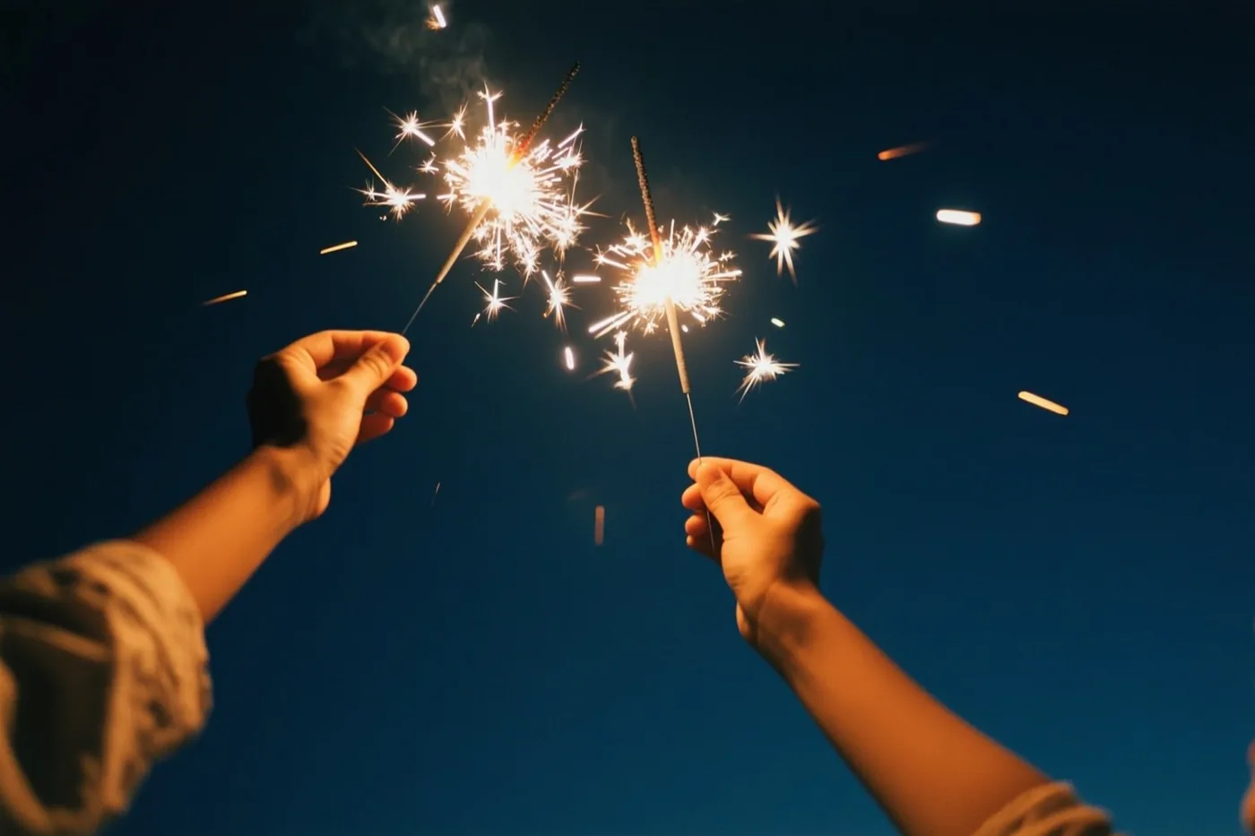 Twee warm verlichte handen houden brandende sterretjes tegen een donkere nachthemel, met stervormige vonken en een witte polaroidrand rond de foto.