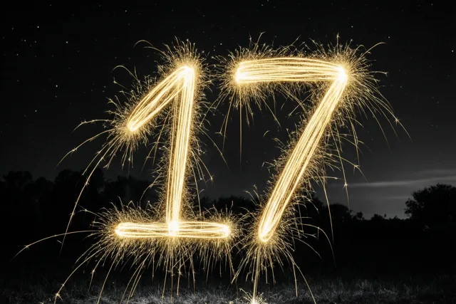 Gouden lichtsporen van sterretjes vormen het getal 17 tegen een donkere hemel met zichtbare sterren.